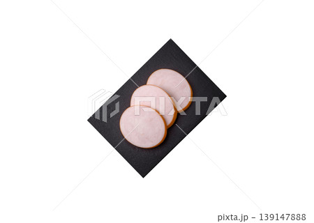 Chicken or Indian cooked sausage or ham sliced for breakfast sandwiches. Chicken sausage slices 139147888