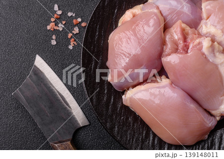 Raw chicken thigh fillet, boneless and skinless, for roasting. Raw thigh fillet Raw chicken thigh fillet, boneless and skinless, for roasting. Raw thigh fillet 139148011
