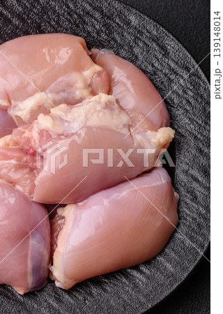 Raw chicken thigh fillet, boneless and skinless, for roasting. Raw thigh fillet Raw chicken thigh fillet, boneless and skinless, for roasting. Raw thigh fillet 139148014