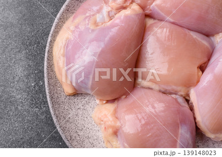 Raw chicken thigh fillet, boneless and skinless, for roasting. Raw thigh fillet 139148023