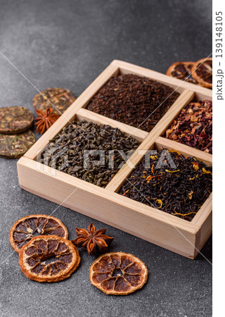 A box of various dry teas, black, green, herbal, and fruit. A set of different tea varieties 139148105