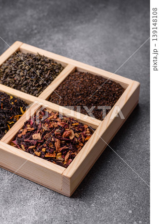 A box of various dry teas, black, green, herbal, and fruit. A set of different tea varieties 139148108