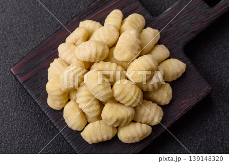 Raw homemade potato gnocchi, made with salt and spices, ready for lunch. Raw gnocchi Raw homemade potato gnocchi, made with salt and spices, ready for lunch. Raw gnocchi 139148320
