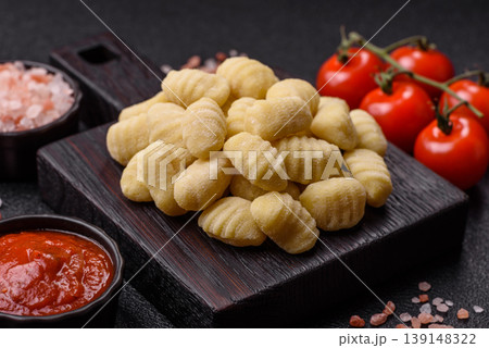 Raw homemade potato gnocchi, made with salt and spices, ready for lunch. Raw gnocchi Raw homemade potato gnocchi, made with salt and spices, ready for lunch. Raw gnocchi 139148322