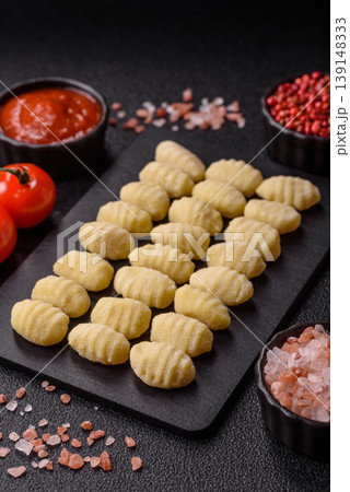 Raw homemade potato gnocchi, made with salt and spices, ready for lunch. Raw gnocchi Raw homemade potato gnocchi, made with salt and spices, ready for lunch. Raw gnocchi 139148333