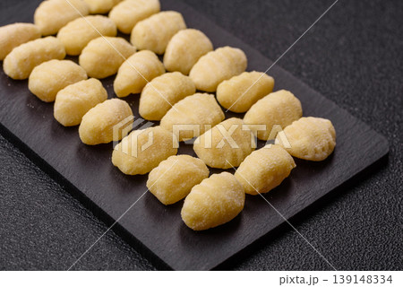 Raw homemade potato gnocchi, made with salt and spices, ready for lunch. Raw gnocchi Raw homemade potato gnocchi, made with salt and spices, ready for lunch. Raw gnocchi 139148334
