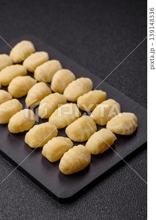 Raw homemade potato gnocchi, made with salt and spices, ready for lunch. Raw gnocchi 139148336