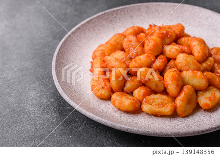 Homemade potato gnocchi with Bolognese sauce, seasoned with salt and spices. Gnocchi with sauce Homemade potato gnocchi with Bolognese sauce, seasoned with salt and spices. Gnocchi with sauce 139148356