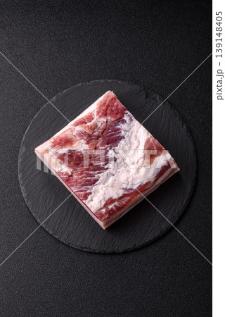 Raw fresh bacon slices with layers of meat or prosciutto prepared for frying. Raw bacon Raw fresh bacon slices with layers of meat or prosciutto prepared for frying. Raw bacon 139148405