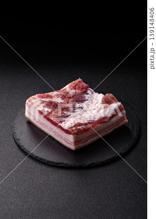Raw fresh bacon slices with layers of meat or prosciutto prepared for frying. Raw bacon 139148406