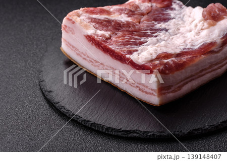Raw fresh bacon slices with layers of meat or prosciutto prepared for frying. Raw bacon 139148407