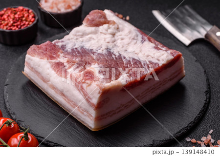 Raw fresh bacon slices with layers of meat or prosciutto prepared for frying. Raw bacon Raw fresh bacon slices with layers of meat or prosciutto prepared for frying. Raw bacon 139148410