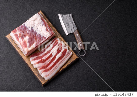Raw fresh bacon slices with layers of meat or prosciutto prepared for frying. Raw bacon Raw fresh bacon slices with layers of meat or prosciutto prepared for frying. Raw bacon 139148437
