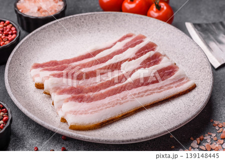 Raw fresh bacon slices with layers of meat or prosciutto prepared for frying. Raw bacon 139148445