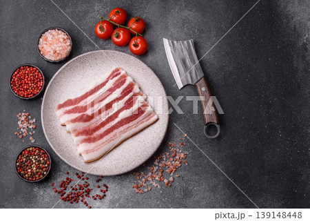 Raw fresh bacon slices with layers of meat or prosciutto prepared for frying. Raw bacon 139148448
