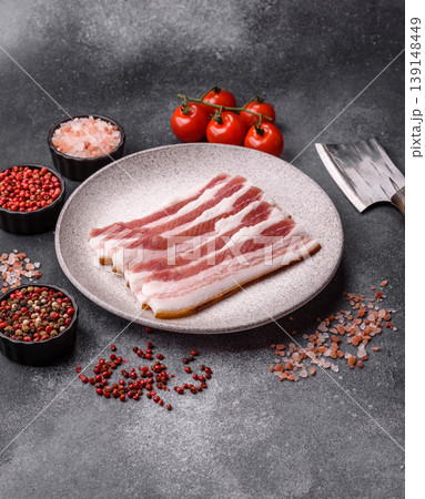 Raw fresh bacon slices with layers of meat or prosciutto prepared for frying. Raw bacon 139148449