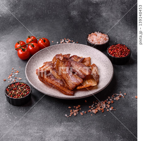 Fried fresh bacon slices with layers of meat or prosciutto prepared for breakfast. Fried bacon Fried fresh bacon slices with layers of meat or prosciutto prepared for breakfast. Fried bacon 139148453