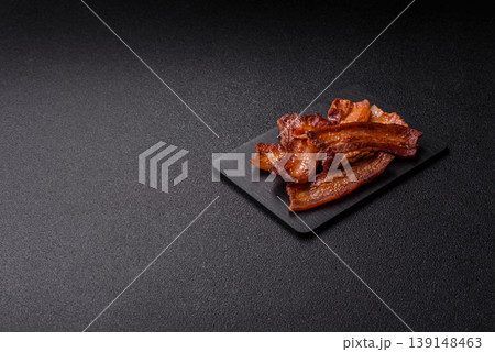 Fried fresh bacon slices with layers of meat or prosciutto prepared for breakfast. Fried bacon 139148463