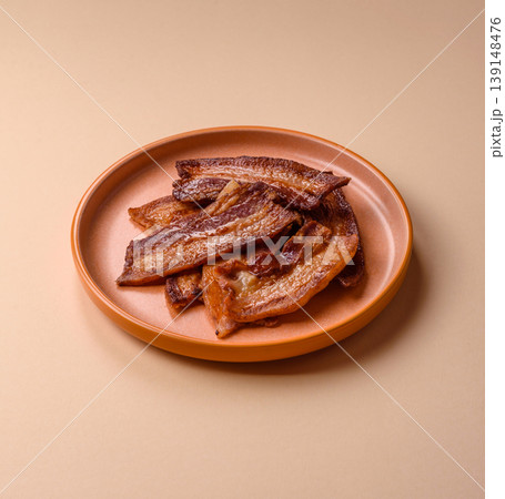 Fried fresh bacon slices with layers of meat or prosciutto prepared for breakfast. Fried bacon 139148476