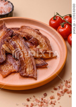 Fried fresh bacon slices with layers of meat or prosciutto prepared for breakfast. Fried bacon Fried fresh bacon slices with layers of meat or prosciutto prepared for breakfast. Fried bacon 139148480