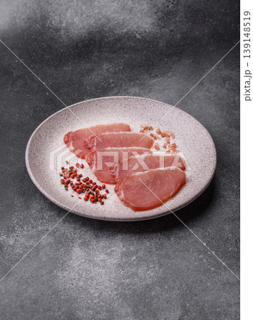 Smoked or dry cured meat slices, pork or ham with salt and spices. Smoked meat slices Smoked or dry cured meat slices, pork or ham with salt and spices. Smoked meat slices 139148519