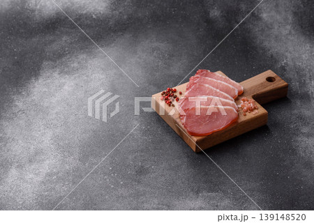 Smoked or dry cured meat slices, pork or ham with salt and spices. Smoked meat slices Smoked or dry cured meat slices, pork or ham with salt and spices. Smoked meat slices 139148520
