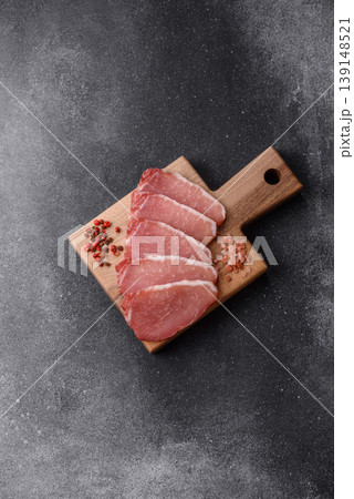 Smoked or dry cured meat slices, pork or ham with salt and spices. Smoked meat slices Smoked or dry cured meat slices, pork or ham with salt and spices. Smoked meat slices 139148521