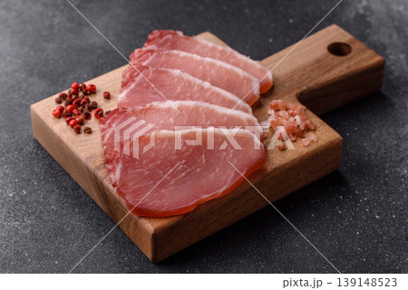 Smoked or dry cured meat slices, pork or ham with salt and spices. Smoked meat slices Smoked or dry cured meat slices, pork or ham with salt and spices. Smoked meat slices 139148523