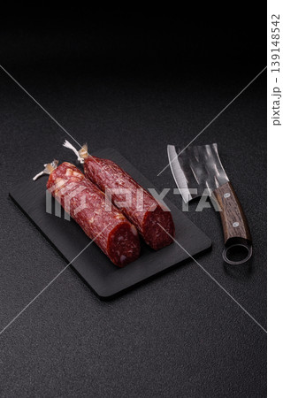 Smoked or dry cured salami slices or ham with salt and spices. Smoked sausage 139148542