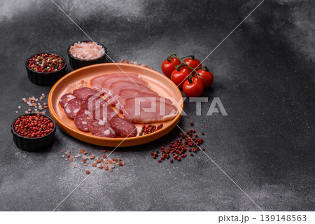 Smoked or dry cured salami slices or ham with salt and spices. Smoked sausage Smoked or dry cured salami slices or ham with salt and spices. Smoked sausage 139148563
