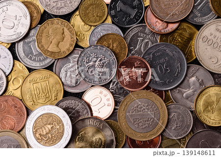 A background of silver, gold, and copper coins of various denominations. Metal coins 139148611