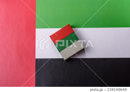 Cargo containers on the UAE flag as a conceptual backdrop for goods export. Cargo containers 139148649