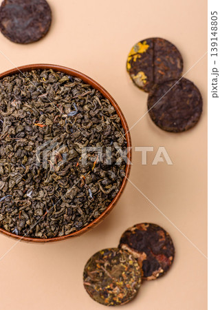 Granules of dried organic Chinese green tea with herbal additives. Dry green tea 139148805