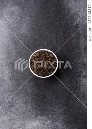Granules of dried organic Chinese green tea with herbal additives. Dry green tea 139148810