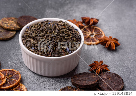 Granules of dried organic Chinese green tea with herbal additives. Dry green tea Granules of dried organic Chinese green tea with herbal additives. Dry green tea 139148814