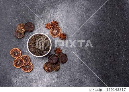 Granules of dried organic Chinese green tea with herbal additives. Dry green tea Granules of dried organic Chinese green tea with herbal additives. Dry green tea 139148817