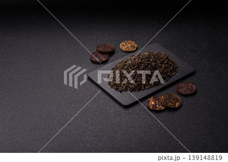 Granules of dried organic Chinese green tea with herbal additives. Dry green tea 139148819