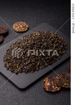 Granules of dried organic Chinese green tea with herbal additives. Dry green tea Granules of dried organic Chinese green tea with herbal additives. Dry green tea 139148823