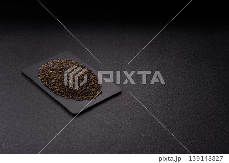 Granules of dried organic Chinese green tea with herbal additives. Dry green tea Granules of dried organic Chinese green tea with herbal additives. Dry green tea 139148827