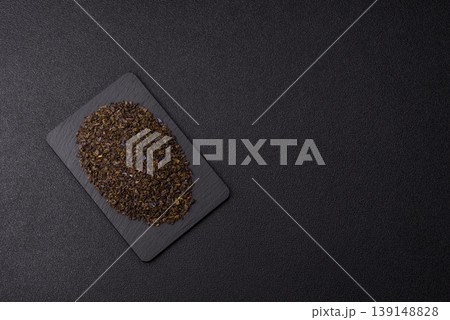 Granules of dried organic Chinese green tea with herbal additives. Dry green tea 139148828