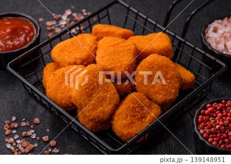 Fried chicken nuggets with sauce, salt, and spices, fast food, unhealthy food. Chicken nuggets 139148951