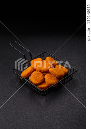 Fried chicken nuggets with sauce, salt, and spices, fast food, unhealthy food. Chicken nuggets Fried chicken nuggets with sauce, salt, and spices, fast food, unhealthy food. Chicken nuggets 139148959