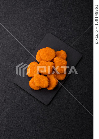 Fried chicken nuggets with sauce, salt, and spices, fast food, unhealthy food. Chicken nuggets 139148961