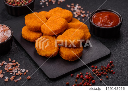 Fried chicken nuggets with sauce, salt, and spices, fast food, unhealthy food. Chicken nuggets 139148966