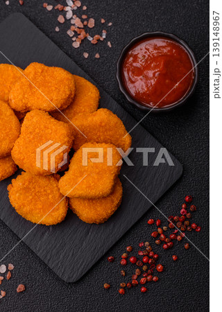 Fried chicken nuggets with sauce, salt, and spices, fast food, unhealthy food. Chicken nuggets Fried chicken nuggets with sauce, salt, and spices, fast food, unhealthy food. Chicken nuggets 139148967