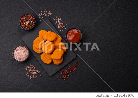 Fried chicken nuggets with sauce, salt, and spices, fast food, unhealthy food. Chicken nuggets Fried chicken nuggets with sauce, salt, and spices, fast food, unhealthy food. Chicken nuggets 139148970