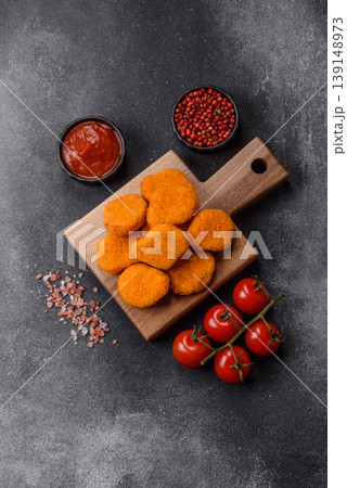 Fried chicken nuggets with sauce, salt, and spices, fast food, unhealthy food. Chicken nuggets Fried chicken nuggets with sauce, salt, and spices, fast food, unhealthy food. Chicken nuggets 139148973