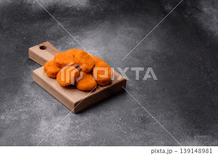 Fried chicken nuggets with sauce, salt, and spices, fast food, unhealthy food. Chicken nuggets 139148981