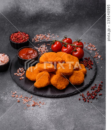 Fried chicken nuggets with sauce, salt, and spices, fast food, unhealthy food. Chicken nuggets 139148995