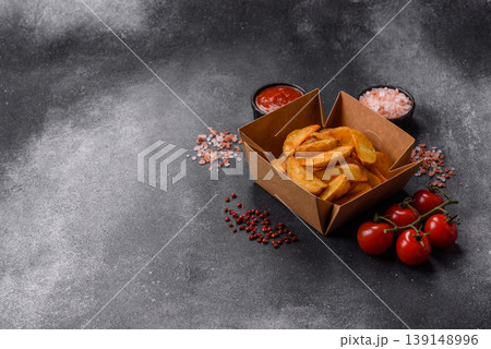 Potato wedges baked with garlic, herbs, and spices for lunch. Potato wedges Potato wedges baked with garlic, herbs, and spices for lunch. Potato wedges 139148996